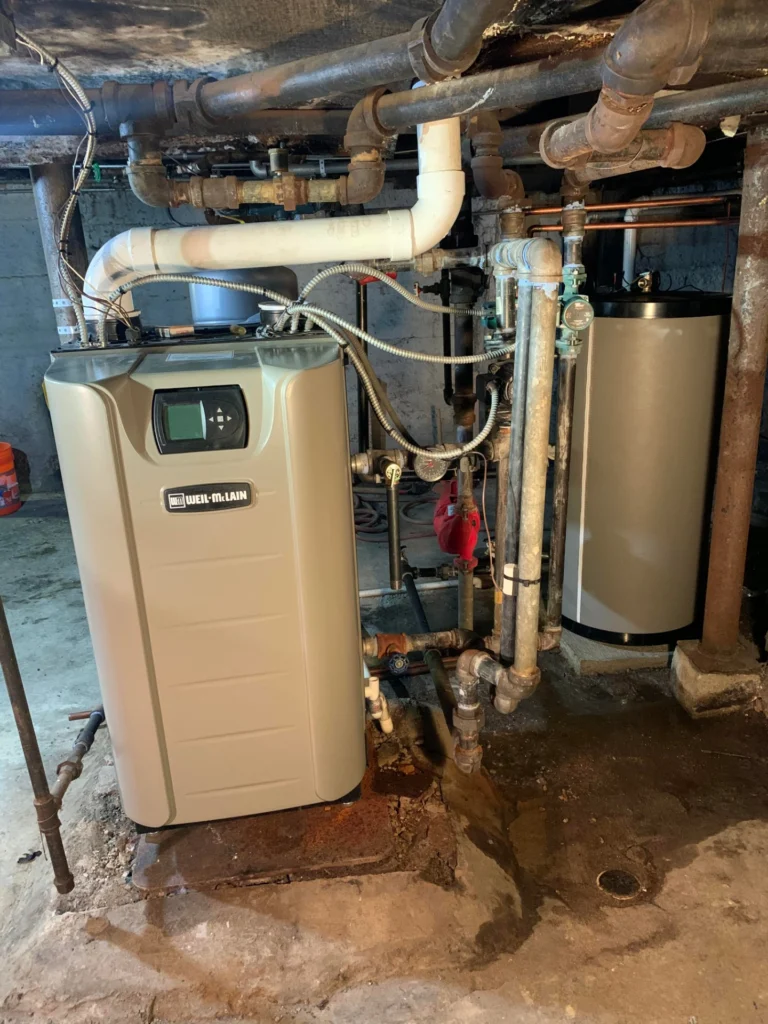 High-efficiency Weil-McLain condensing boiler paired with an indirect water storage tank for reliable home heating and hot water performance.